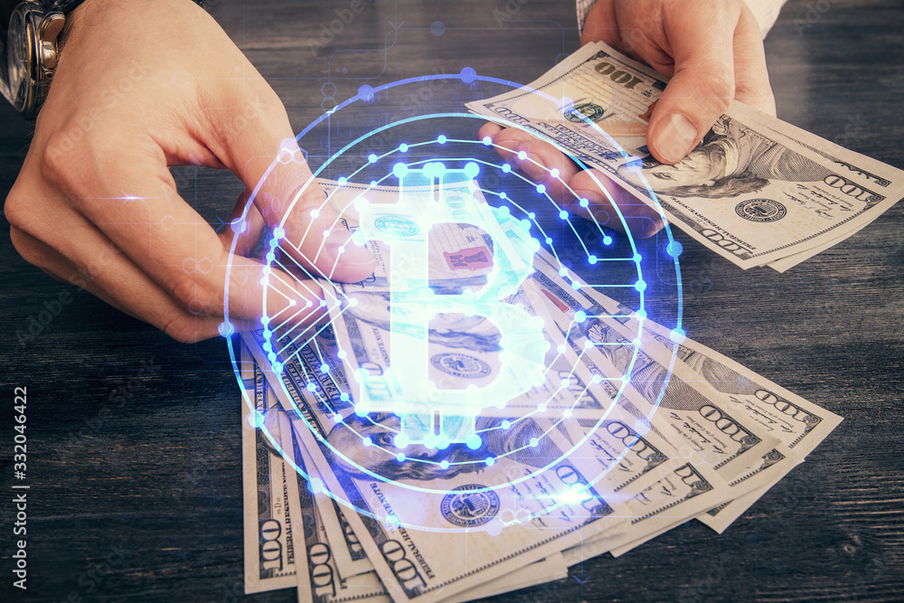 Multi exposure of blockchain theme drawing hologram and USA dollars bills and man hands. Business concept. Multi exposure of blockchain theme drawing hologram and USA dollars bills and man hands. Business concept.