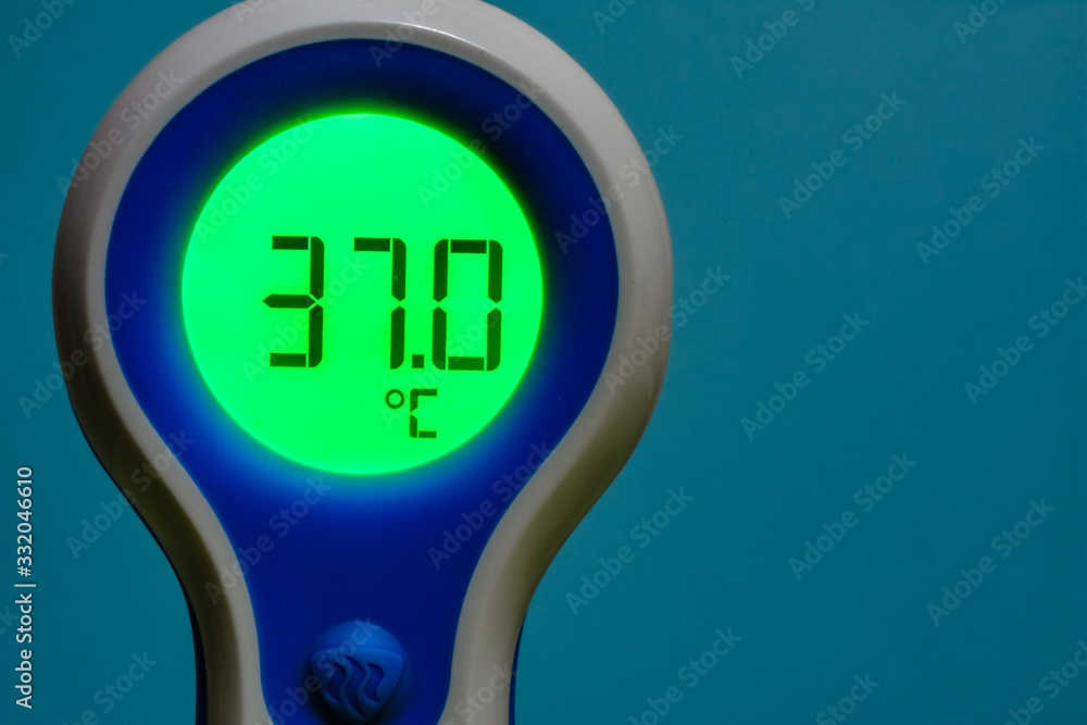 Contactless thermometer showing normal body temperature. Stock Photo
