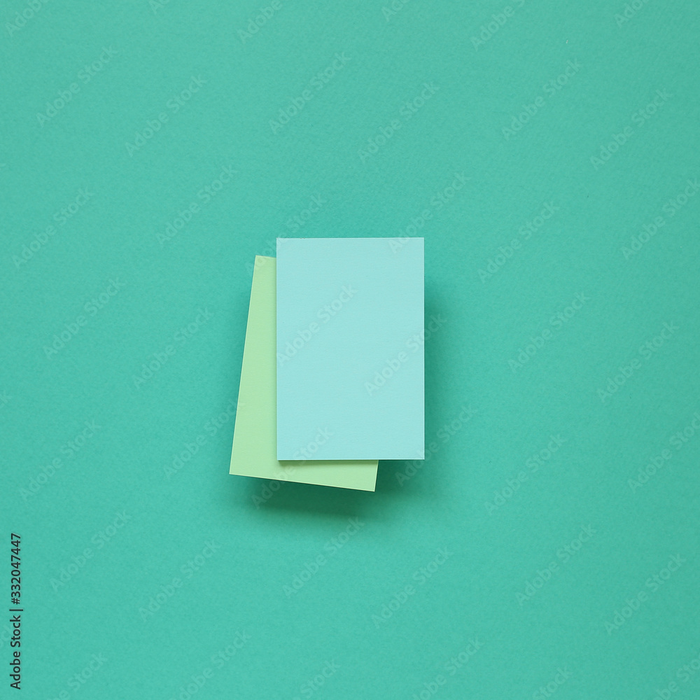 Blue memo paper, sticky notes on mint green background. top view, copy space Blue memo paper, sticky notes on mint green background. top view, copy space