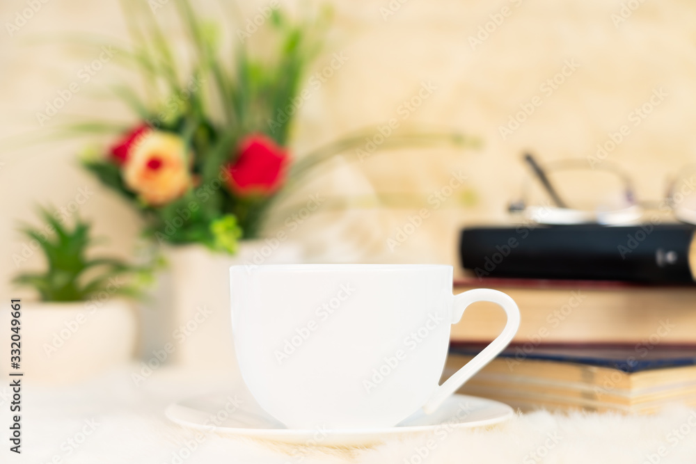 Cup of coffee with book stacked on table Cup of coffee with book stacked on table