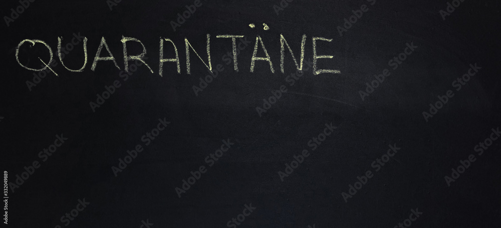 Fototapeta premium The word is in German quarantine. The text on the chalk Board. Yellow chalk. banner