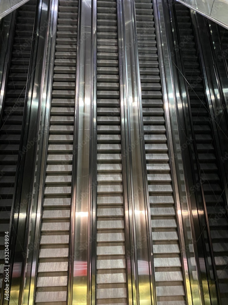 Obraz premium escalator in business center, escalator at train station, escalator at the undergroud, subway, metro station, stainless steel, upstairs, picture from upstairs