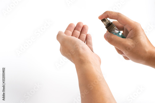 Man hands applying alcohol sanitizer spray or anti bacteria spray to another hand for prevent spread of virus  bacteria and germs. COVID-19 Pandemic Coronavirus prevention and personal hygiene concept