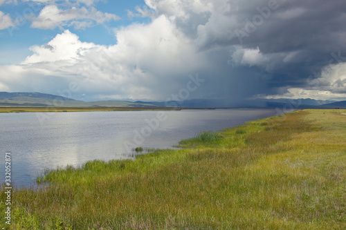 Storm clouds over grasslands and mountains at Red Rock Lake in Centennial Valley  near Lakeview  MT