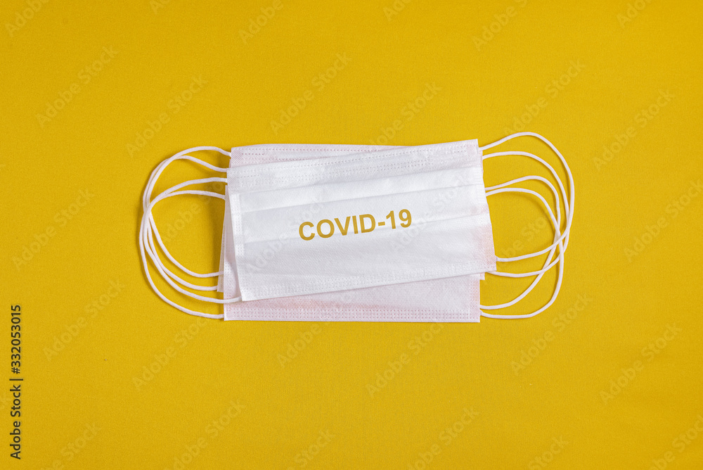 Surgical mask over minimalist orange background Surgical mask over minimalist orange background