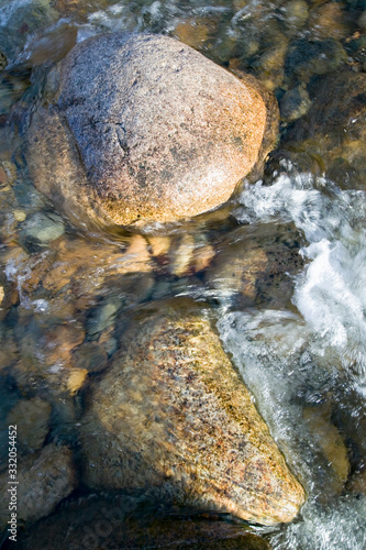Rock in autumn stream at Crawford Notch State Park in White Mountains of New Hampshire  New England