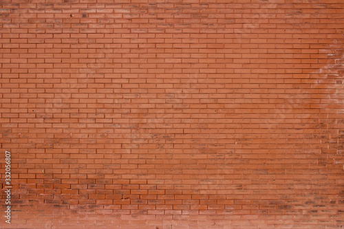 Vintage burnt orange color brick wall background with grungy texture