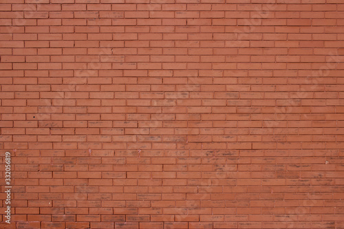 Vintage burnt orange color brick wall background with grungy texture