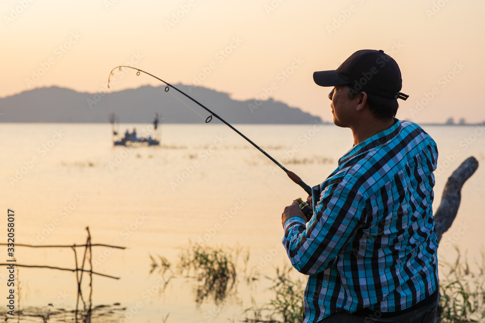 Office man self quarantine in with the nature by fishing in the lake. Quarantine concept Office man self quarantine in with the nature by fishing in the lake. Quarantine concept