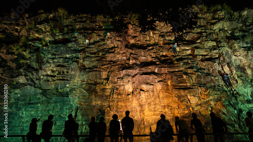 rock climbing night time on the cliff wall assistant people silhouette Brisbane Australia Kangaroo point wide angle