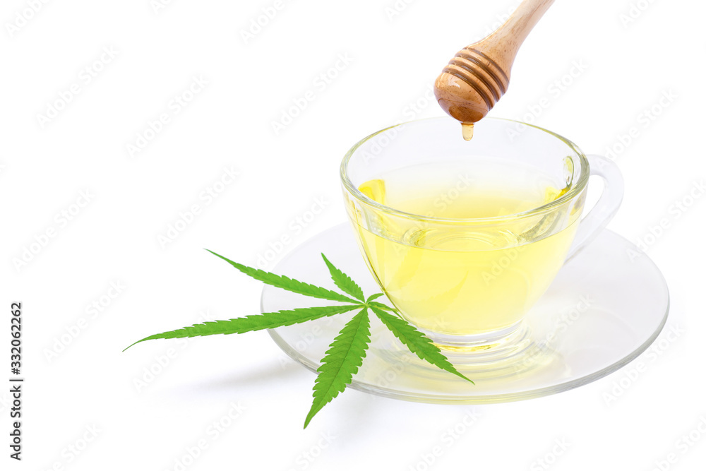 Cup of cannabis tea isolated on white Cup of cannabis tea isolated on white