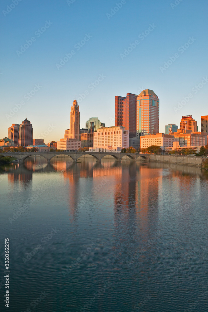 Scioto River and Columbus Ohio skyline in autumn with sunset reflection in water