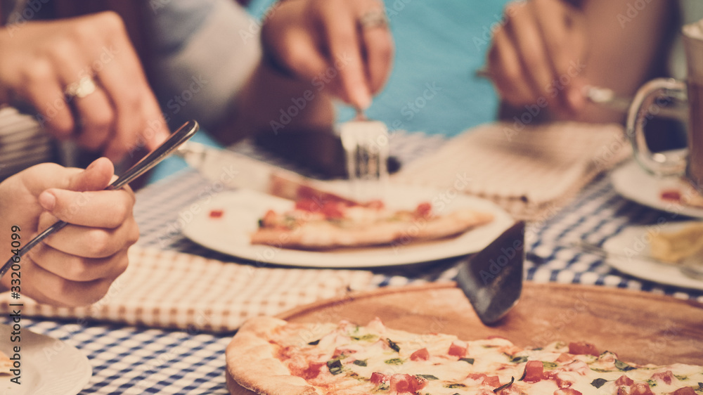 Closeup of young woman eating delicious pizza at their girlish party Closeup of young woman eating delicious pizza at their girlish party