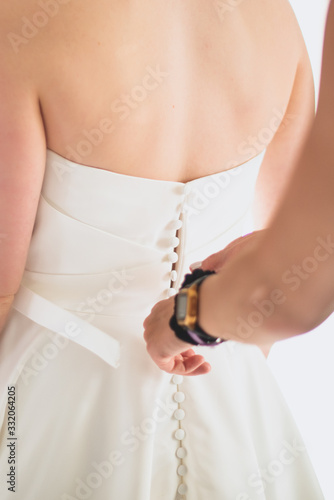 A wedding dress or bridal gown which is the dress worn by the bride during a wedding ceremony.