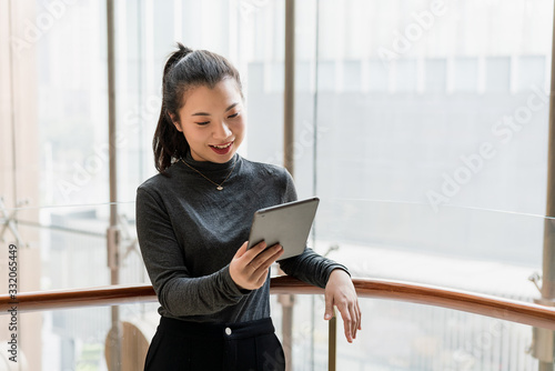 A young business woman uses a tablet computer in the building