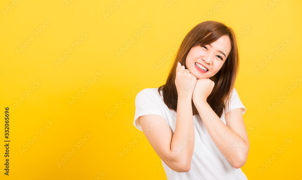 woman teen stand wear t-shirt happy expression fist pressed together under chin woman teen stand wear t-shirt happy expression fist pressed together under chin