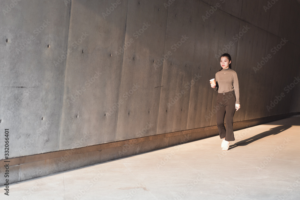 Asian young business women in front of gray walls Asian young business women in front of gray walls