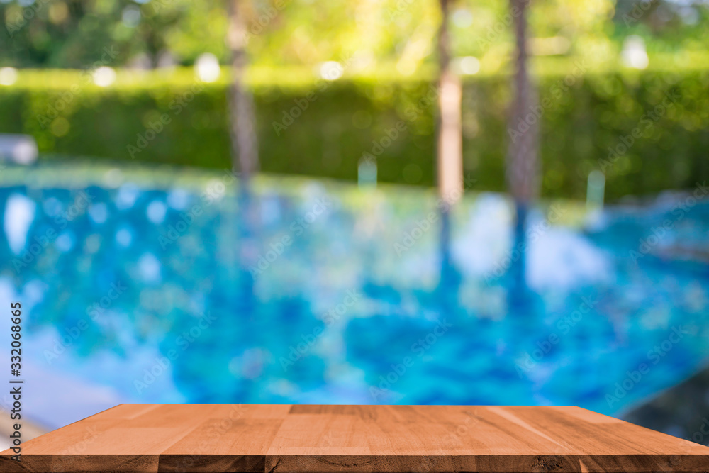 display products on the table, background beside the pool behind the accommodation