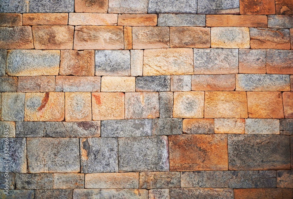 Naklejka premium Ancient Stone wall texture from multi color stone