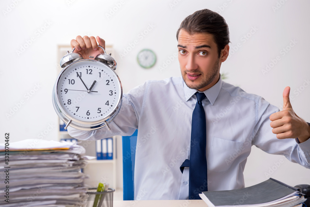 Young male businessman employee unhappy with excessive work Young male businessman employee unhappy with excessive work
