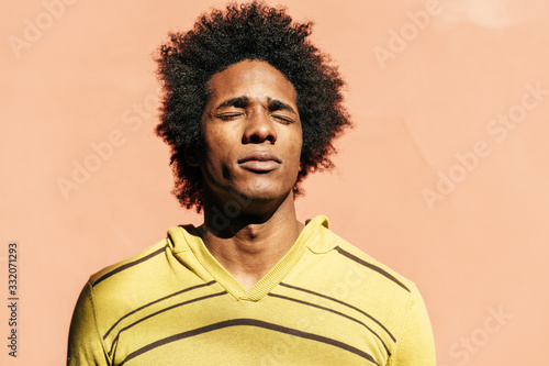 Cuban black man enjoying the andalusian sun with his eyes closed