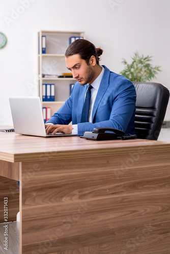 Young male businessman employee working in the office