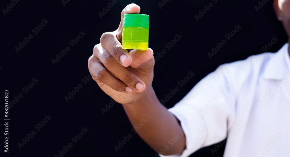 Nurse or Young doctor holding drug bottle on black background. Concept of Corona Virus Nurse or Young doctor holding drug bottle on black background. Concept of Corona Virus