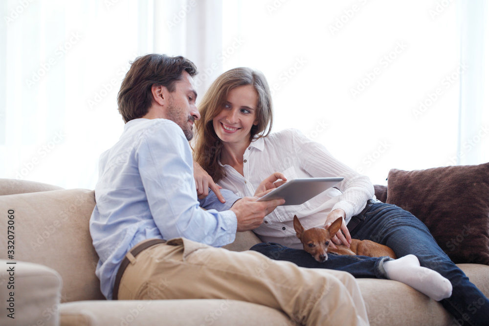 Couple at home with pet dog