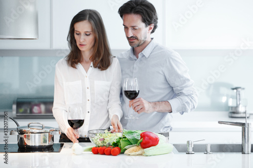 Couple cooking and drinking wine