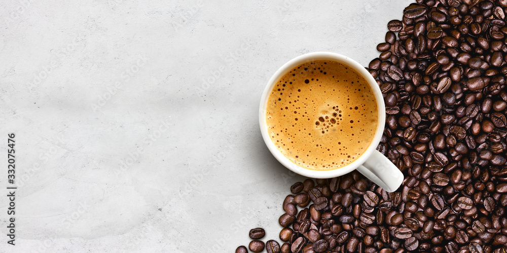 cup of coffee and bean on cement table background