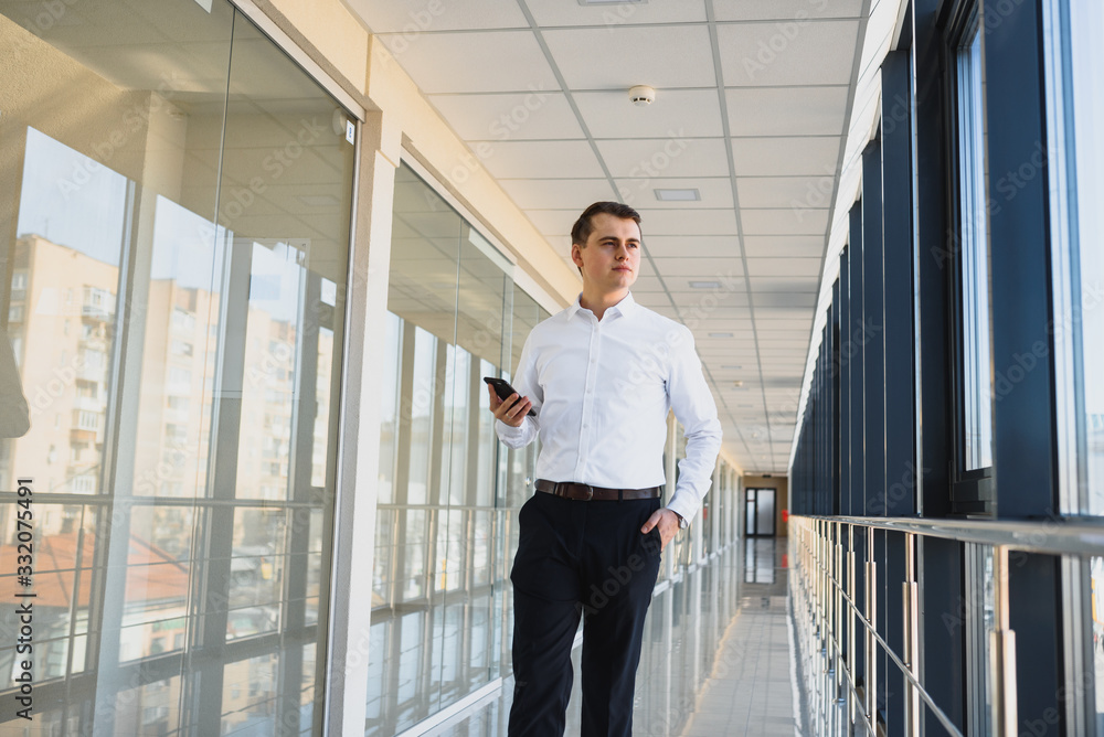 Fototapeta premium Businessman walking in the hall entrance
