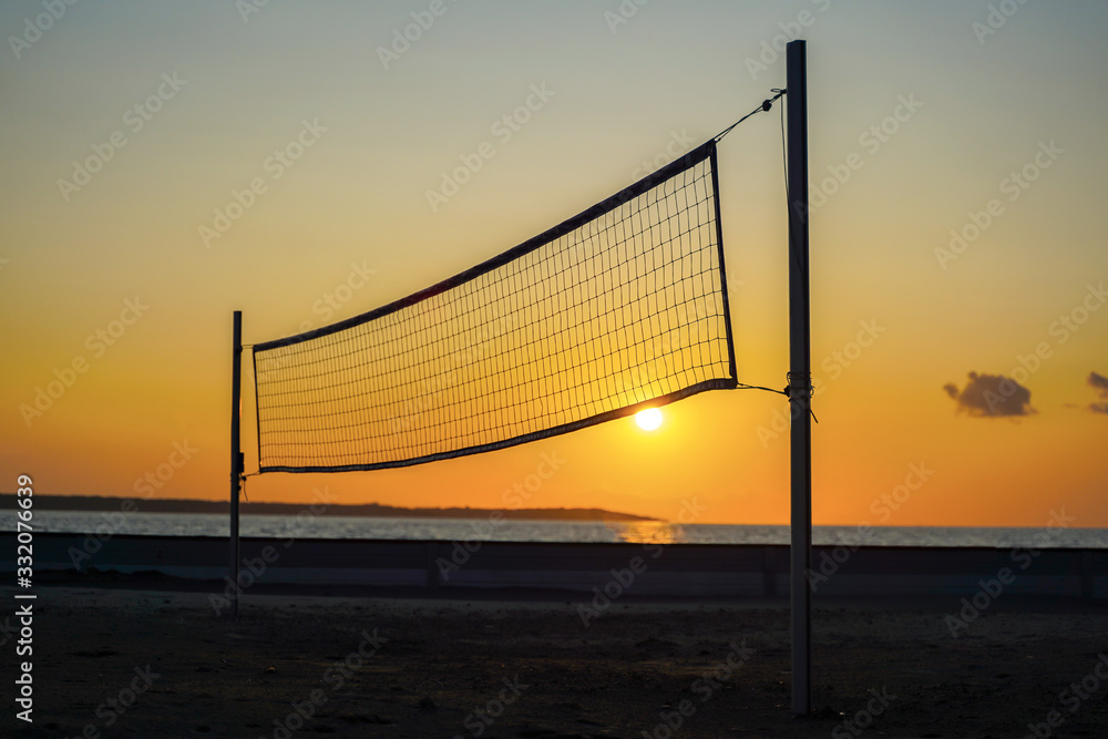 Sillhouette of a volleyball net against sunset on the beach Sillhouette of a volleyball net against sunset on the beach