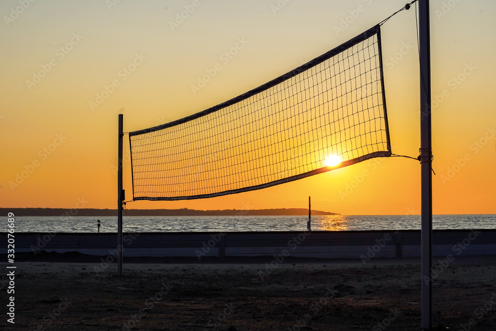 Sillhouette of a volleyball net against sunset on the beach Sillhouette of a volleyball net against sunset on the beach