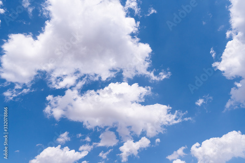 Fototapeta Naklejka Na Ścianę i Meble -  The blue sky with moving white clouds. The most of clouds are beautiful color and shade, suitable for use as background image.