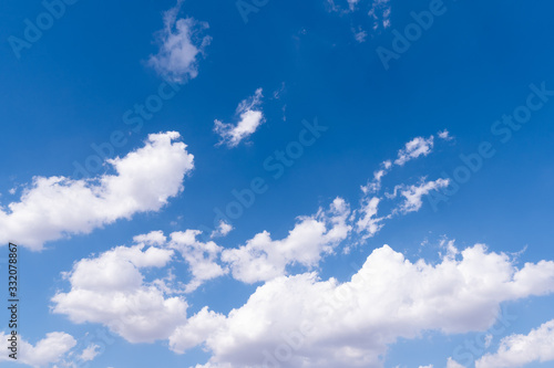 The blue sky with moving white clouds. The most of clouds are beautiful color and shade, suitable for use as background image.