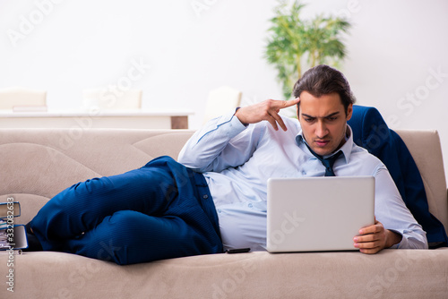 Young male employee working from house