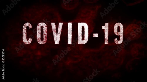 Scary animation of “COVID-19” text and corona virus under microscope red and dark orange background, with the camera panning out to reveal the text. photo