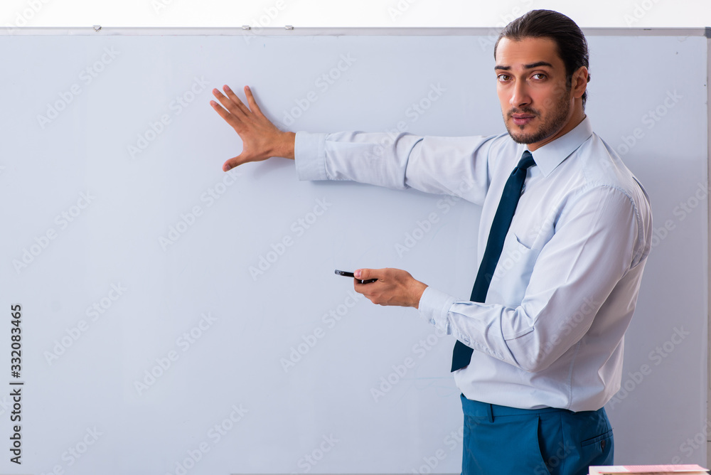 Young male employee in business presentation concept Young male employee in business presentation concept