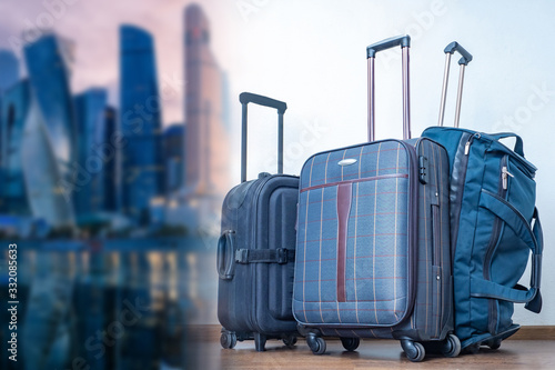 Suitcases on wheels on a bl...