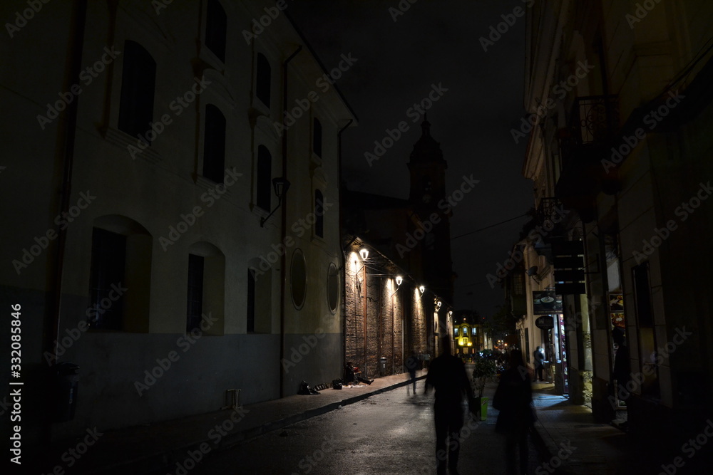 People walking in Bogota old town at night