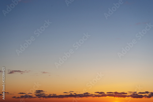 Beautiful clear  morning sky at sunrise  natural background. Soft gradient from orange to blue.