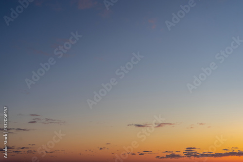Beautiful clear, morning sky at sunrise, natural background. Soft gradient from orange to blue. © Elena Shi