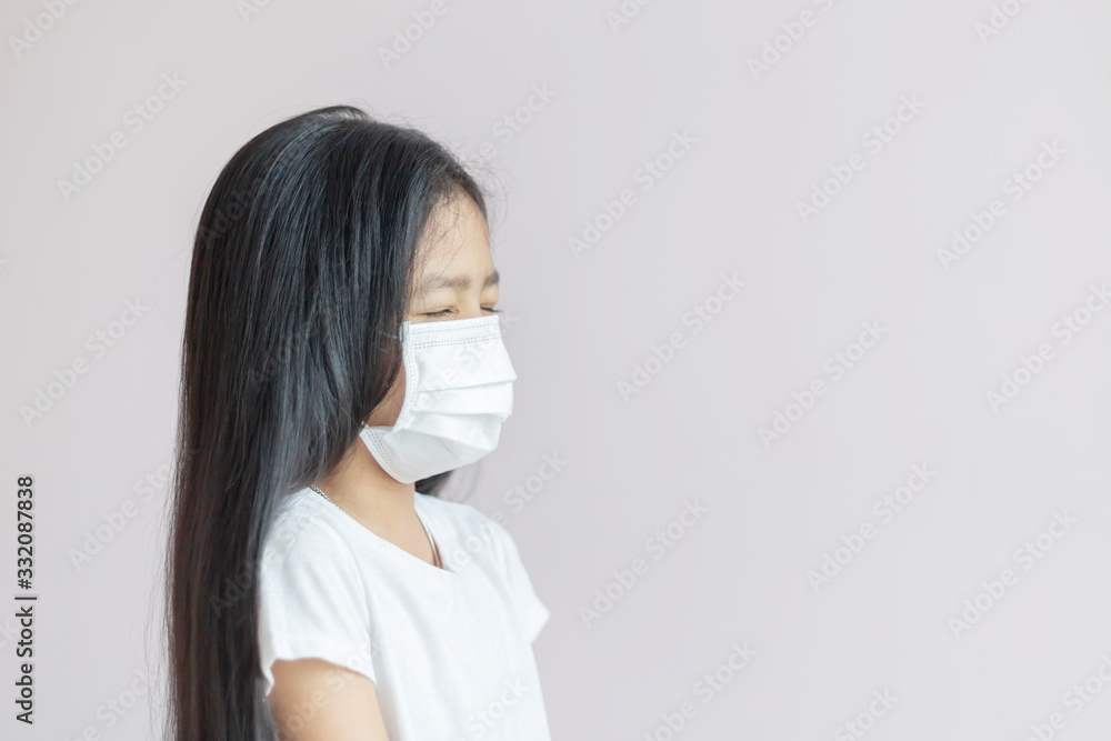 Asian little girl wearing a protective medical mask