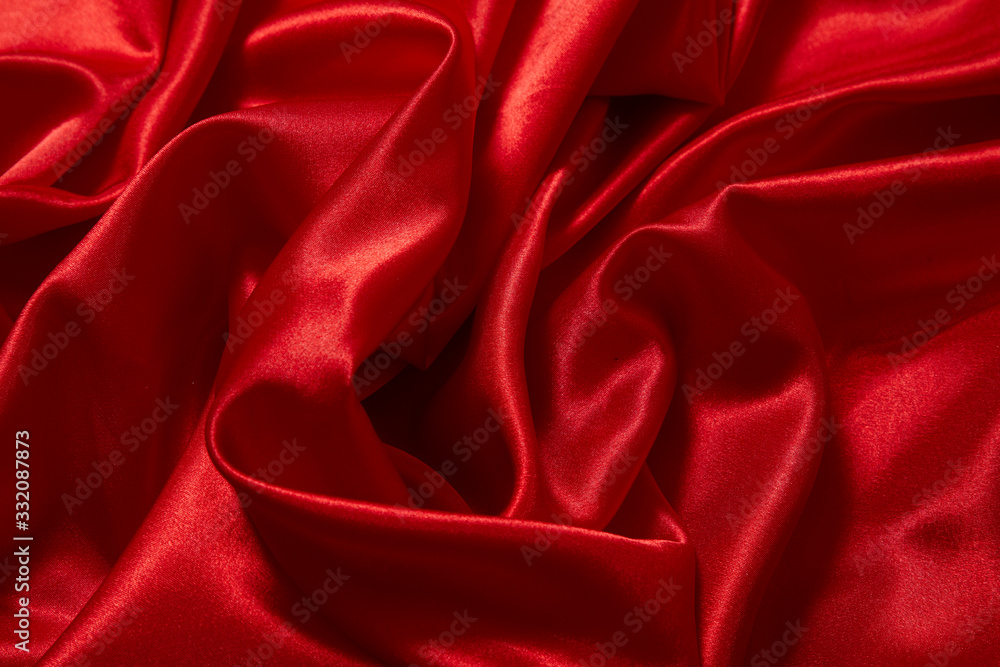 Obraz premium Luxury red satin smooth fabric background for celebration, ceremony, event invitation card or advertising poster