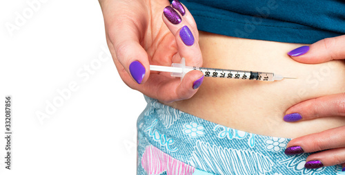 Diabetes patient make insulin shot by syringe. Woman use Insulin injection pen. Diabetes medical care. Dependent diabetes woman make a subcutaneous injection by syringe. photo