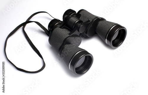 Black binoculars on white background. photo