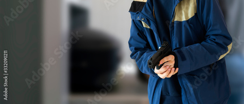 close up terrorist with a black pistol in public street place of the city photo