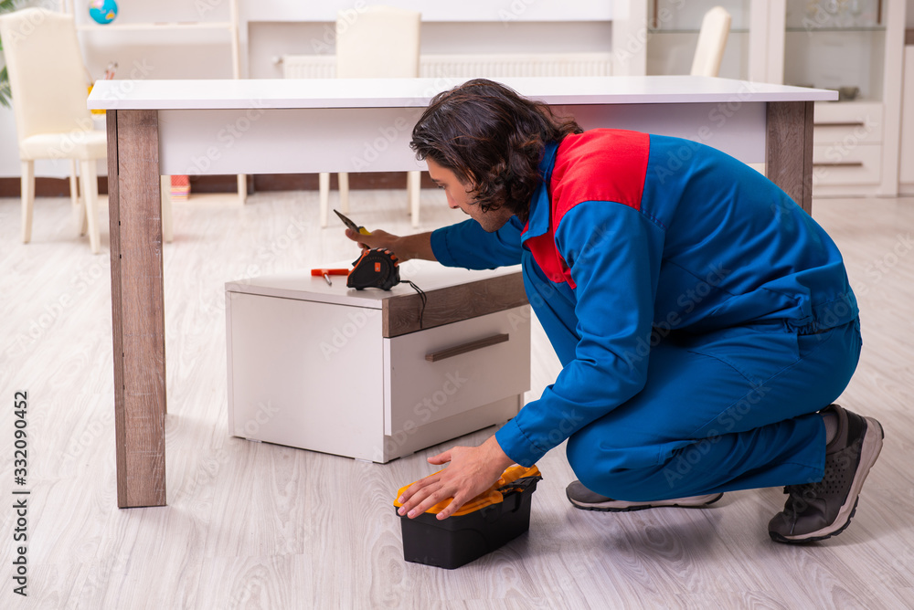 Young male carpenter working indoors Young male carpenter working indoors