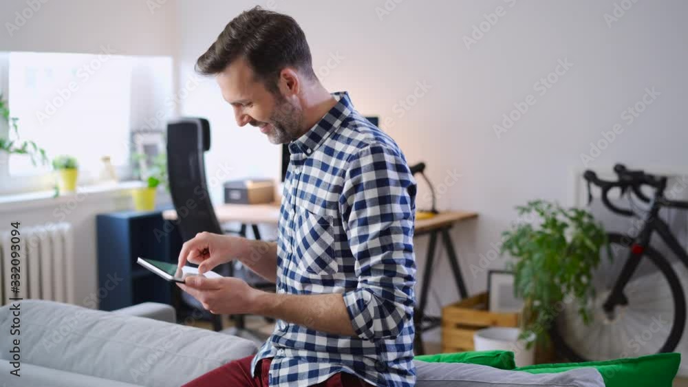 Man at home using digital tablet Man at home using digital tablet