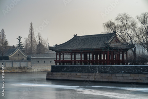 Pavilion by the moat, water became frozen at the Forbidden City in winter, Beijing, China.